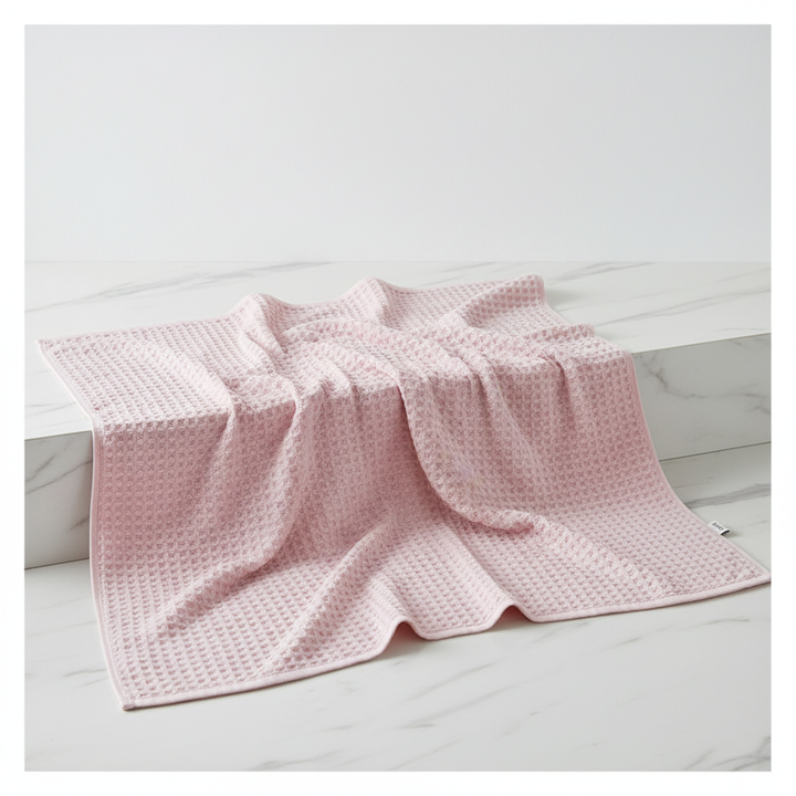 Collection of FreshWrap Pima cotton waffle towels in varied sizes, perfect for a luxurious, quick-dry home essential set