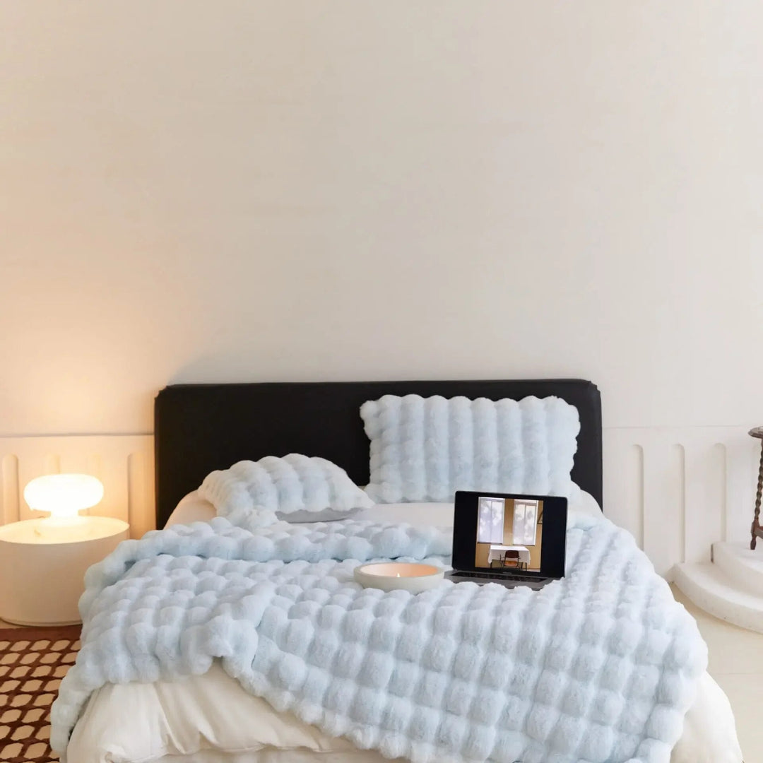 Unisex ultra-soft fleece throw blanket providing plush warmth and cozy comfort for home relaxation.