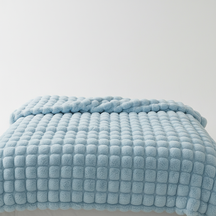 Ultra-soft plush blanket with a subtle texture, designed for maximum comfort and warmth as home decor.