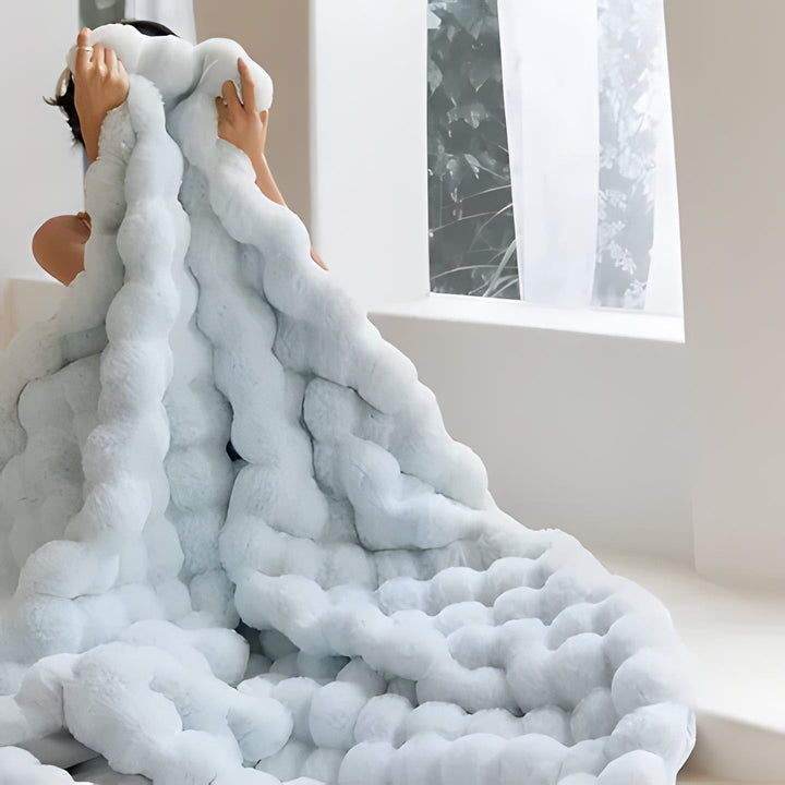 Elegant faux fur throw blanket, an ultra-soft and warm gift idea, enhancing any home's living room or bedroom decor.