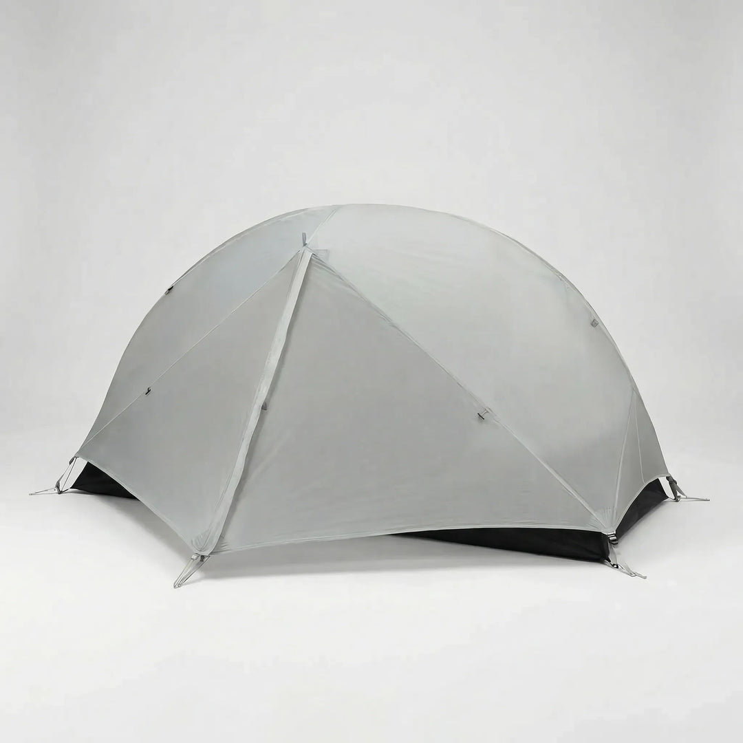 Green ultralight 1-person hiking tent pitched on a mountain trail, essential backpacking gear for solo adventurers.