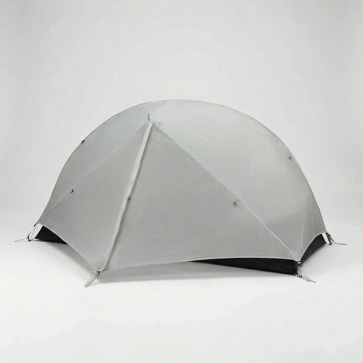 Green ultralight 1-person hiking tent pitched on a mountain trail, essential backpacking gear for solo adventurers.