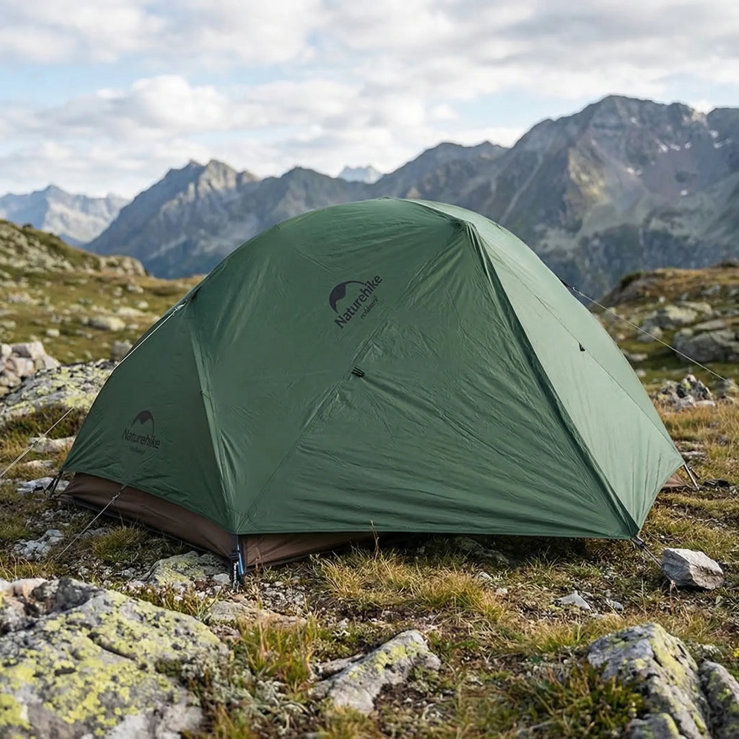 Ultralight 2-person 3-season backpacking dome tent set up outdoors, ideal for hiking and camping.