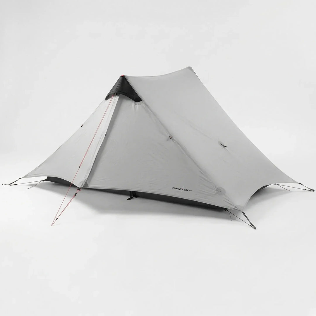 Ultralight 2-person backpacking tent packed in a stuff sack, highlighting its portability for adventure travel.