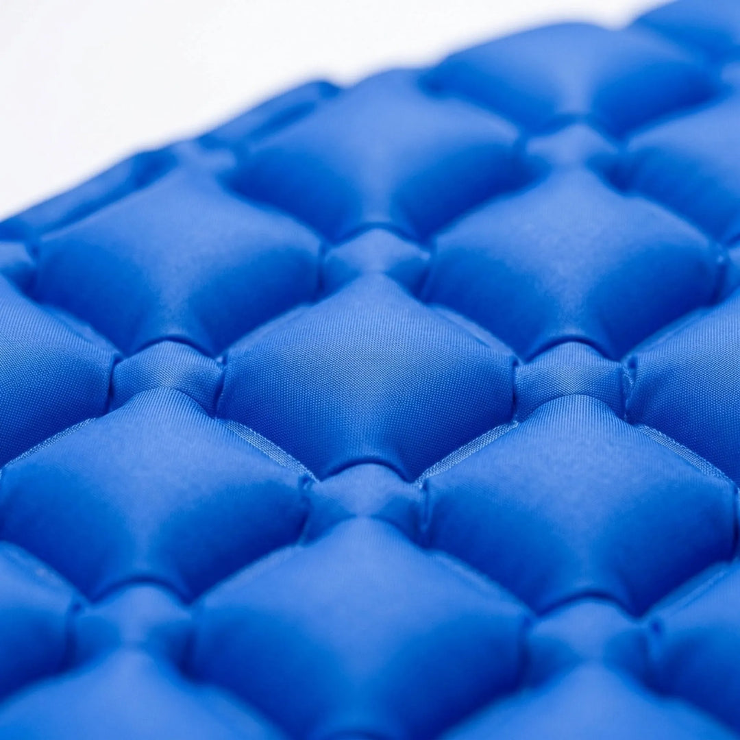 Portable outdoor sleeping pad, ultralight design for camping and hiking, easy to inflate with built-in pump.