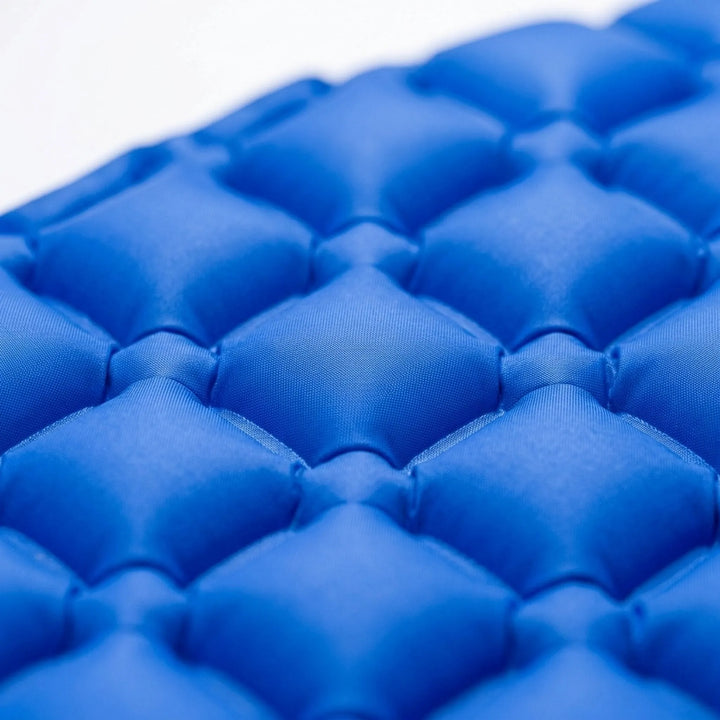 Portable outdoor sleeping pad, ultralight design for camping and hiking, easy to inflate with built-in pump.