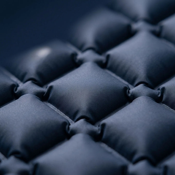 Comfortable inflatable sleeping pad with built-in pillow, ideal for camping, hiking, and outdoor rest.