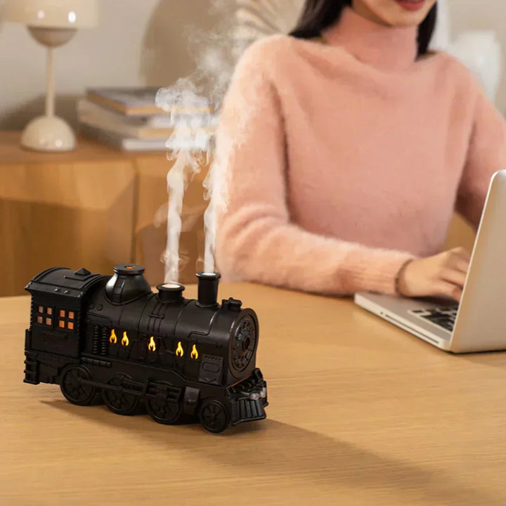 Locomotive aromatherapy diffuser creating a soothing steam mist. Perfect for essential oils, relaxation, & home ambiance.