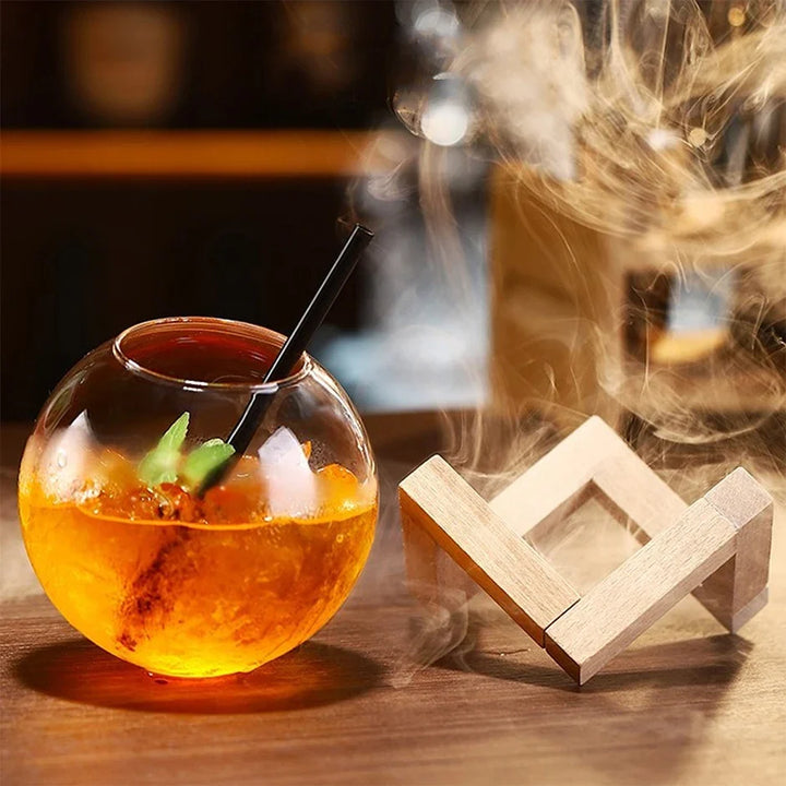 Clear spherical moon ball drinkware on a minimalist wooden base, a unique glassware piece for any modern kitchen.