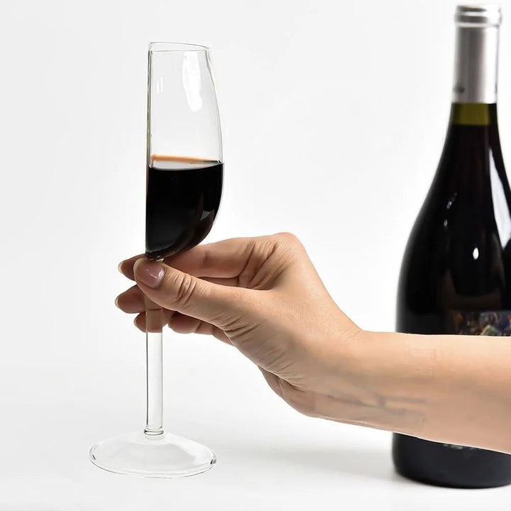 Artistic clear stemmed wine glass, featuring a sculptural half-full bowl, elegant tableware for modern home decor.