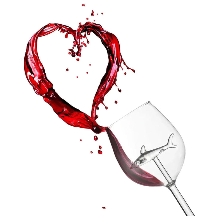 Clear glass tumbler featuring a captivating shark figure, great for any beverage or home decor.