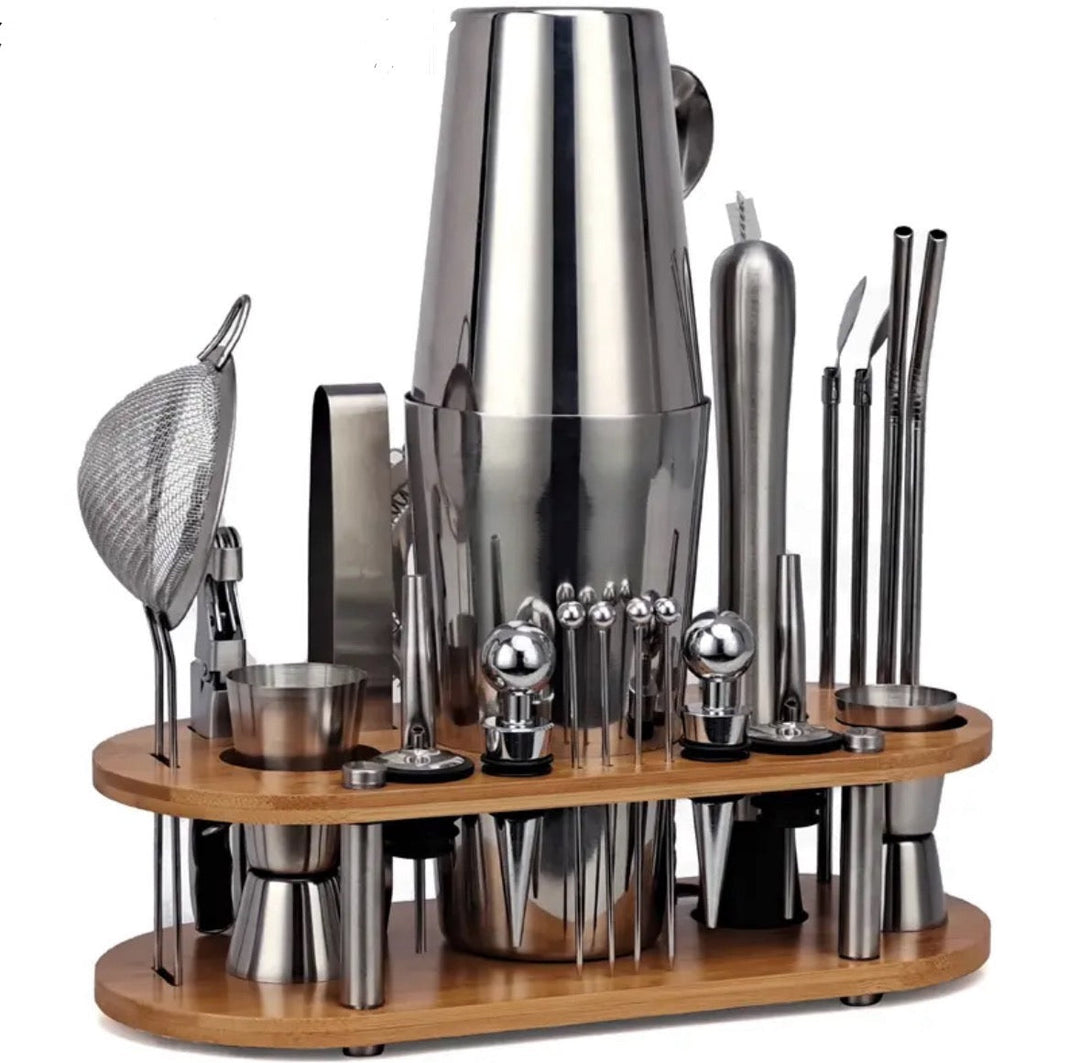 Bartender using a sleek 23-piece stainless steel cocktail kit to craft drinks for entertaining guests.