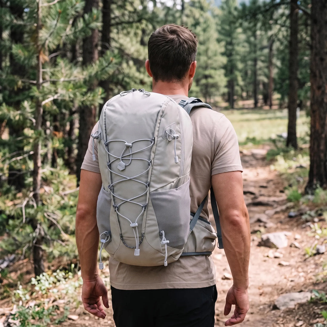 Unisex 6.6-gallon hiking daypack with integrated rain cover for outdoor adventures on trails & camping trips.