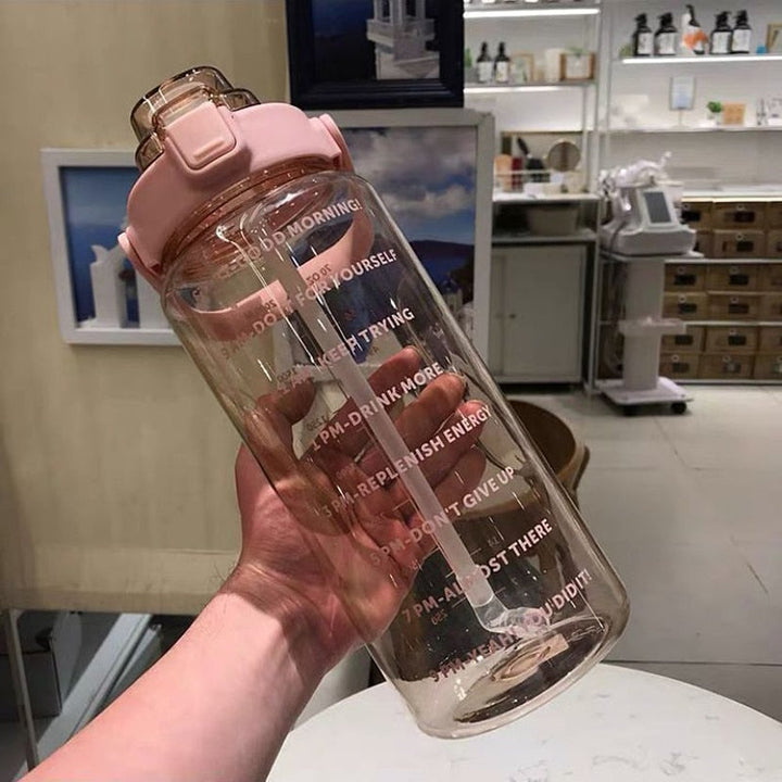 Motivational 64 fl oz water bottle, BPA-free, leak-proof, portable, with time markers for fitness.