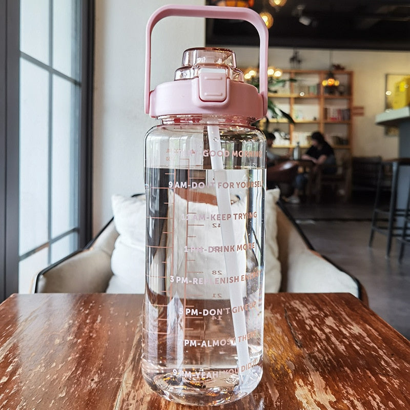 Half gallon motivational gym water bottle, BPA-free and leak-proof, with time markers for fitness.