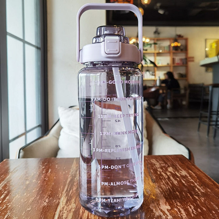 Portable 64 oz BPA-free hydration bottle with time markers, ideal for sports, gym, and daily motivation.