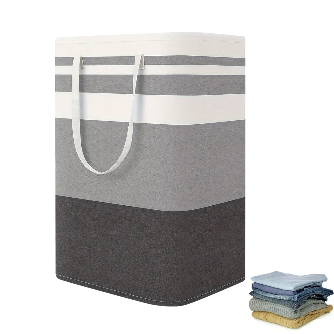 Unisex 75L large striped laundry hamper with handles, collapsed, showing space-saving design in a modern home setting