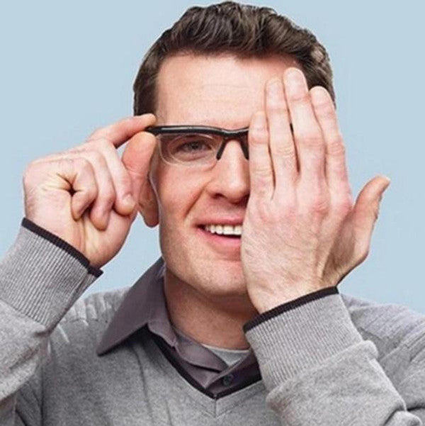 Person wearing adjustable eyewear, easily customizing their vision from reading to distance.