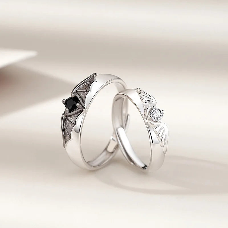 Close-up of a unique Angel and Demon couple ring set with sparkling crystals. Nontarnish, adjustable rings.