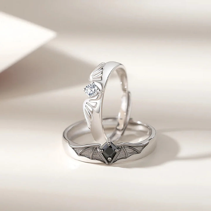 Two hands wearing the adjustable Angel and Demon couple ring set. Features crystal accents and a nontarnish finish.