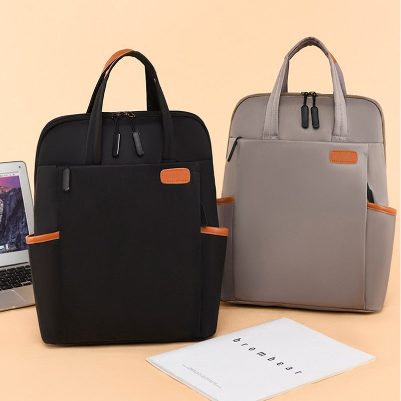 Front view of the black water-resistant Oxford backpack, perfect for travel and daily commute.