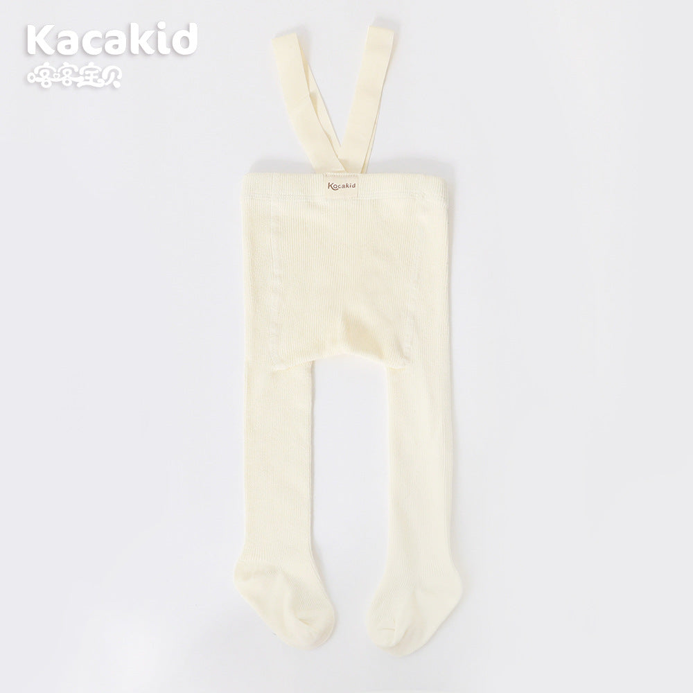 Close-up of the soft texture on unisex baby knitted high-waisted trousers, infant pants.