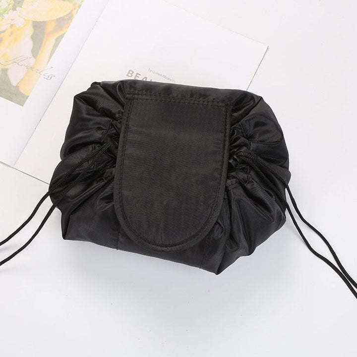 Portable drawstring toiletry bag in a suitcase, demonstrating its space-saving travel organization