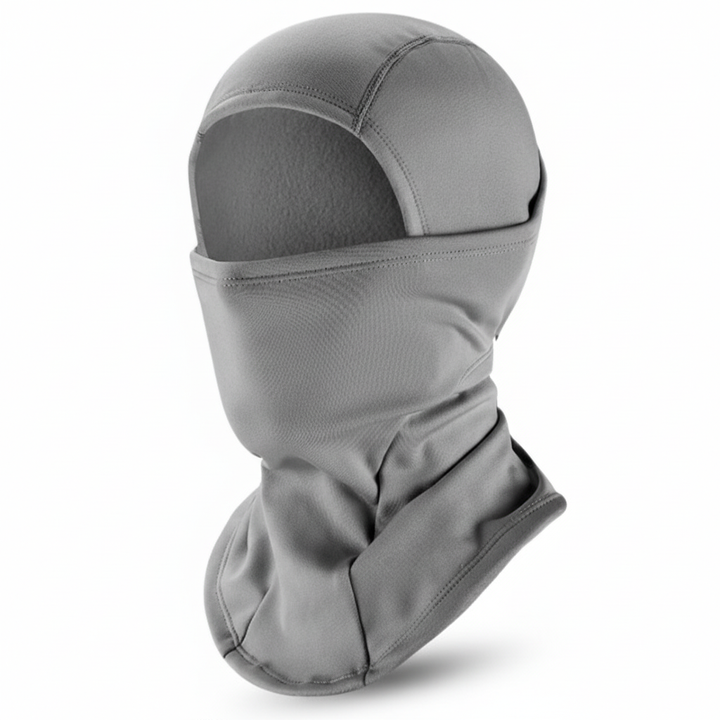 Green unisex fleece beanie modeled on a person, showing fit for ski and cold outdoor use.