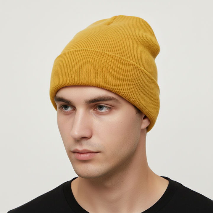 Hand holding a soft knitted acrylic beanie, 'FrostKnit' embroidered, emphasizing comfort and warmth.