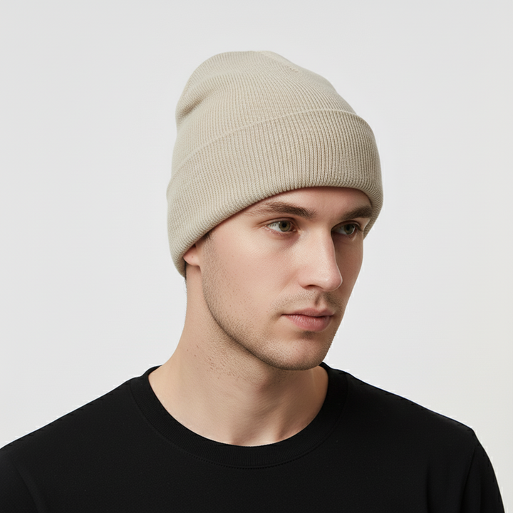 Close-up of a blue knitted acrylic beanie, 'FrostKnit' embroidered, showing soft texture & unisex design.