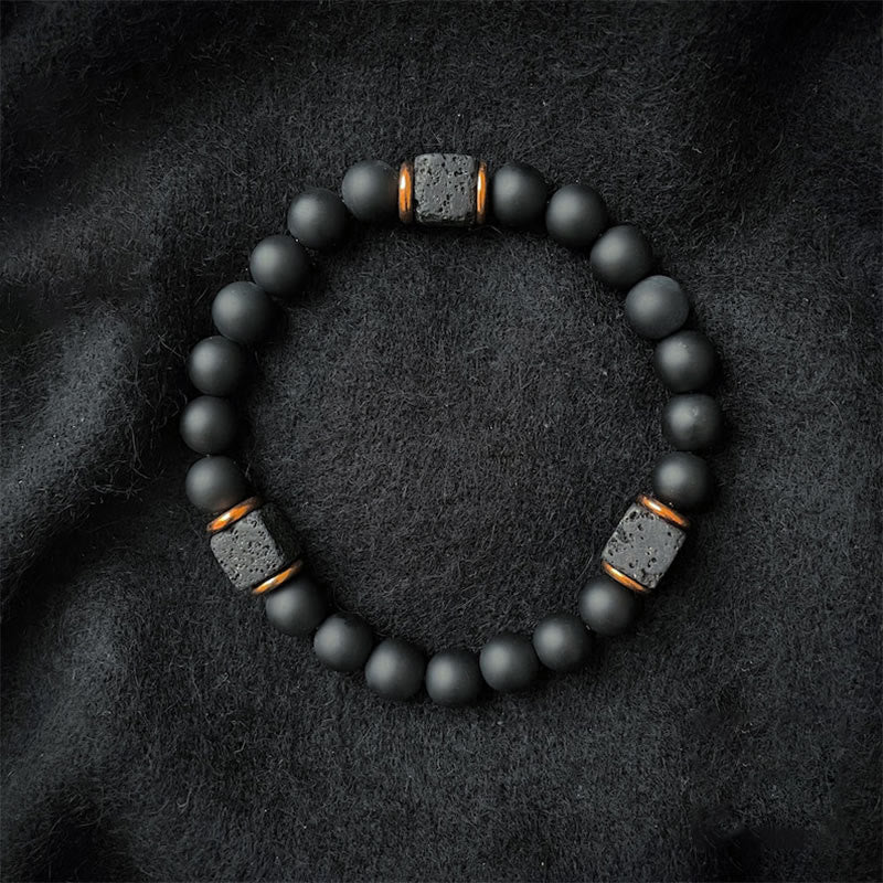 Rugged black onyx and lava stone unisex gemstone bracelet, symbolizing balance and protection.