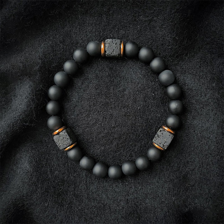 Rugged black onyx and lava stone unisex gemstone bracelet, symbolizing balance and protection.