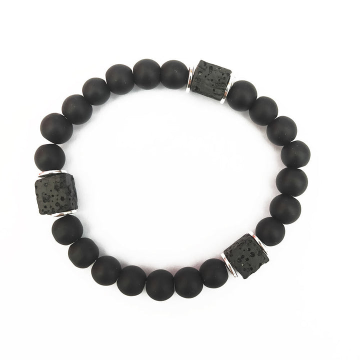 Adjustable unisex bracelet with black onyx and lava stone cubes, perfect for a minimalist, strong style.