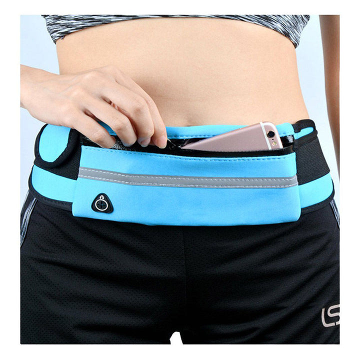 Model wearing a black water-resistant running belt while jogging outdoors, front view.