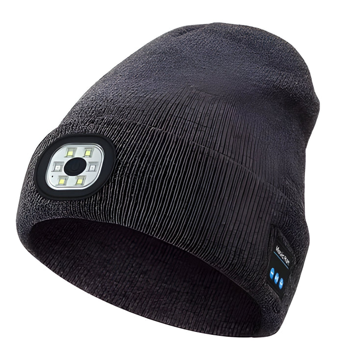 Person running at night wearing a black LED beanie with a bright hands-free headlamp, safe for outdoor activities.