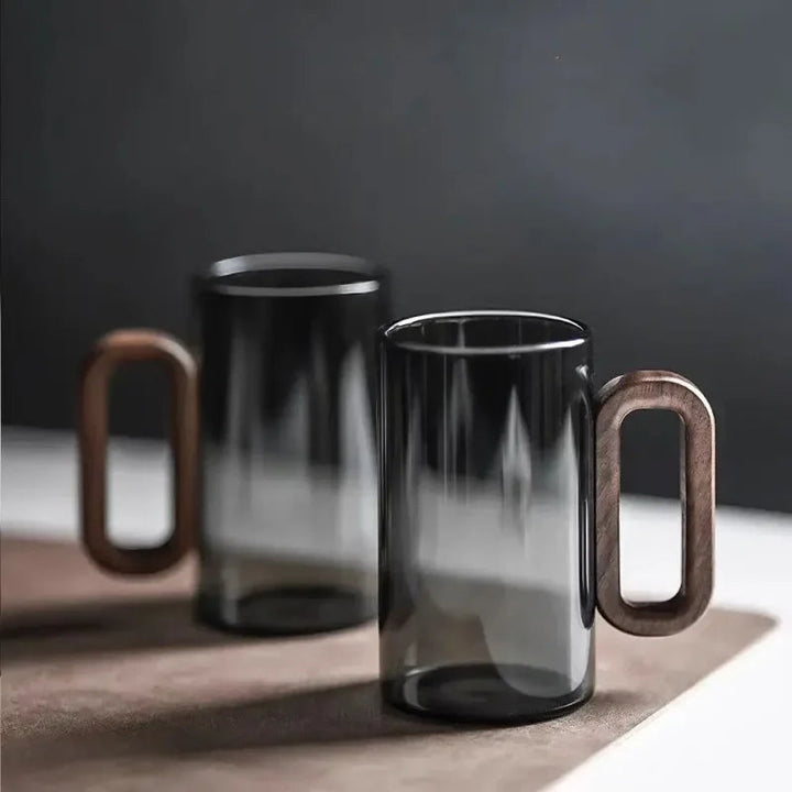 Unisex borosilicate glass mug with stylish walnut handle, perfect for coffee or tea. Durable drinkware.