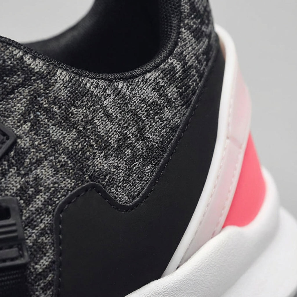 Side view of unisex athletic shoes, breathable design, and durable rubber sole for active wear.