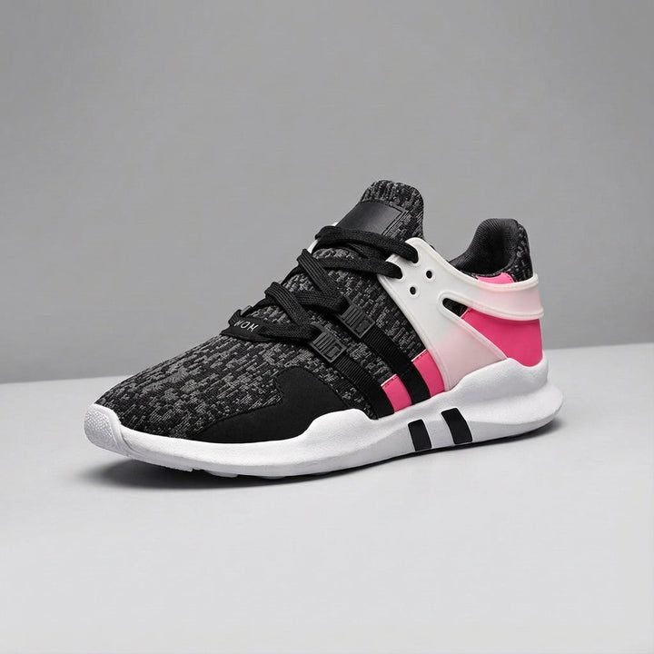 Close-up of the breathable fabric and durable rubber sole on unisex comfort trainers, laced.