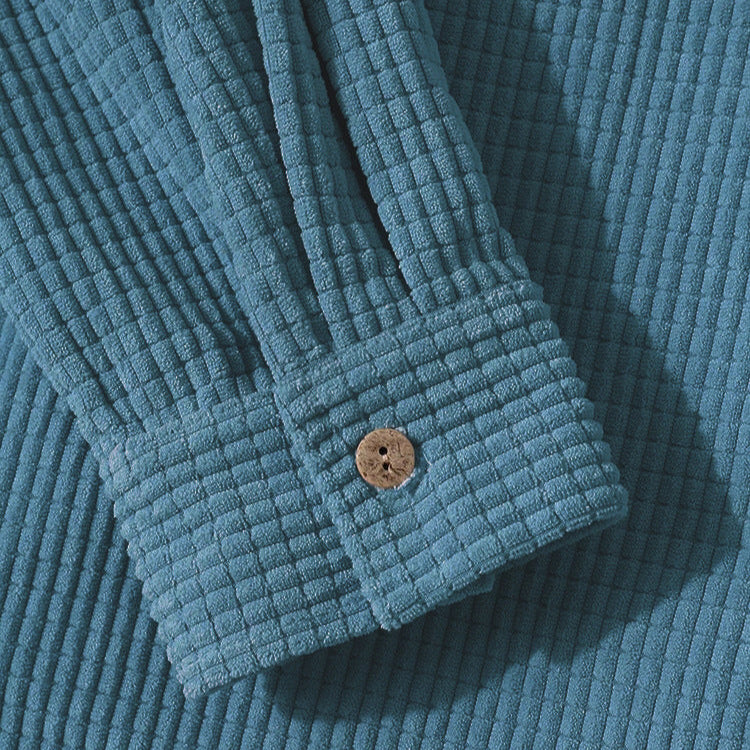Casual unisex hooded jacket featuring a textured fabric and button-up front, perfect for everyday style.