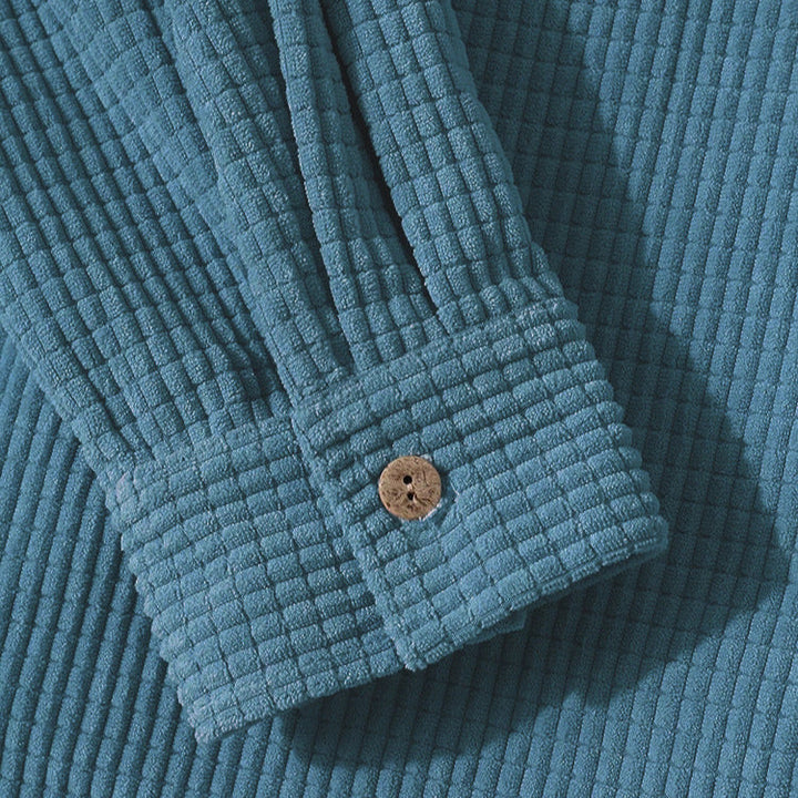 Casual unisex hooded jacket featuring a textured fabric and button-up front, perfect for everyday style.