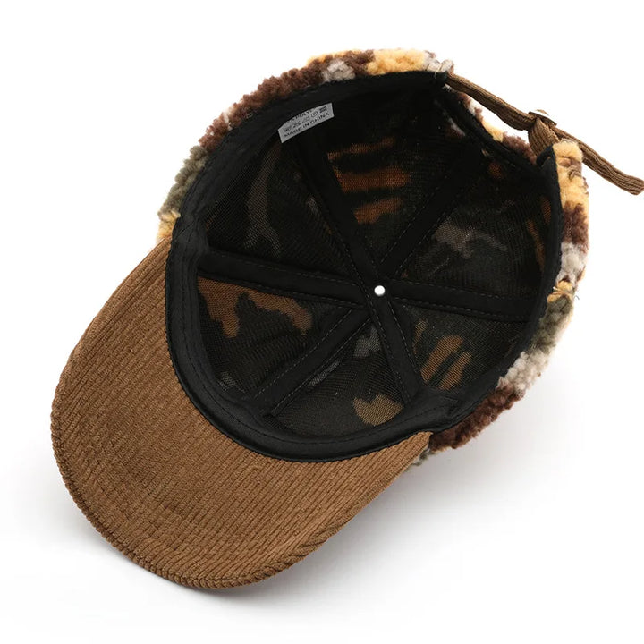 Close-up of a cozy camo plush hat, showing soft fleece texture and corduroy brim detail.