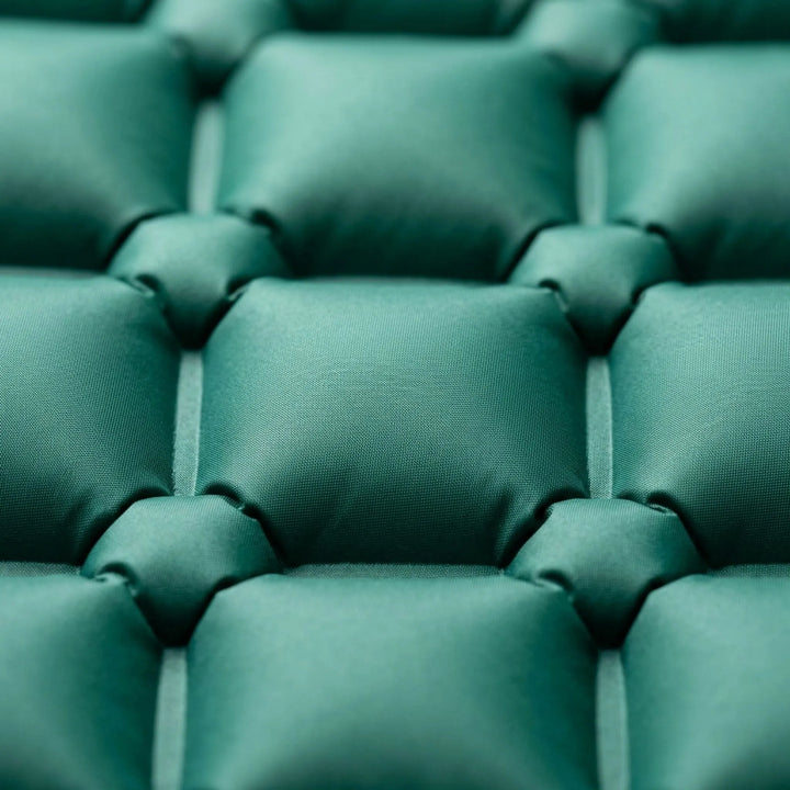 Comfortable unisex sleeping mat with integrated pillow, perfect lightweight camping gear for hikers.