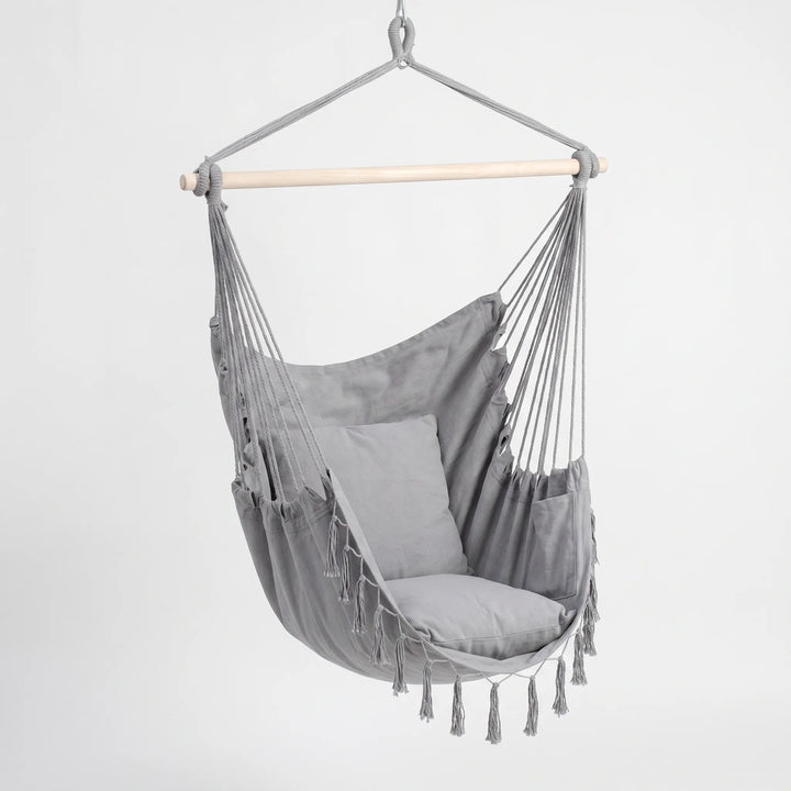 Relaxing unisex swing chair with cushions for indoor/outdoor use. Bohemian hanging hammock seat for comfort.