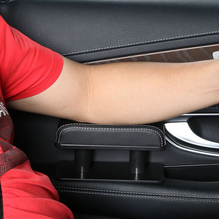 Padded leather car armrest cushion, non-slip and universal fit for drivers. Enhances comfort in any vehicle interior.