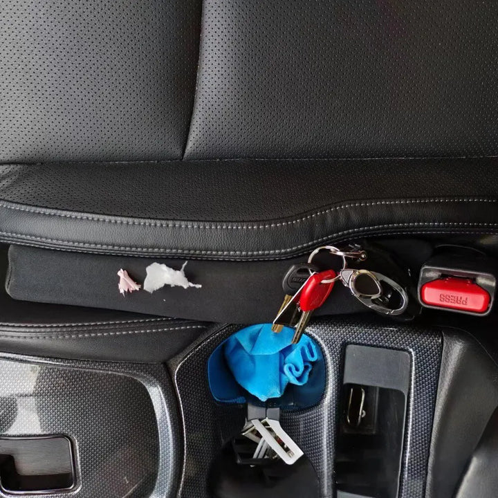 Two black car seat gap fillers. Spill-proof strips prevent items from falling into car seat gaps.