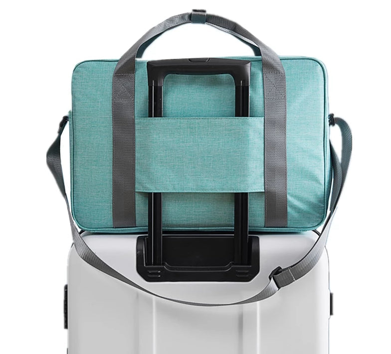 Unisex carry-on travel bag attaches to suitcase handle for easy airport navigation. Lightweight and practical travel accessory.