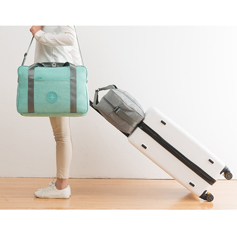 Practical unisex carry-on luggage, slides over suitcase handle for convenient, lightweight, and organized airport trips.