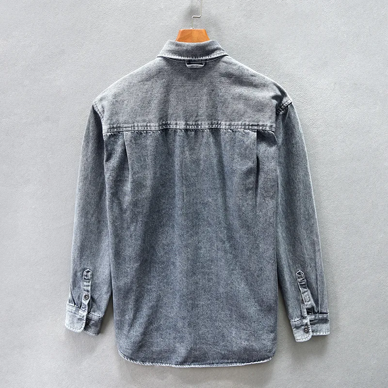 Close-up of a stylish gray casual button-up shirt, showing the fabric texture and functional buttons.