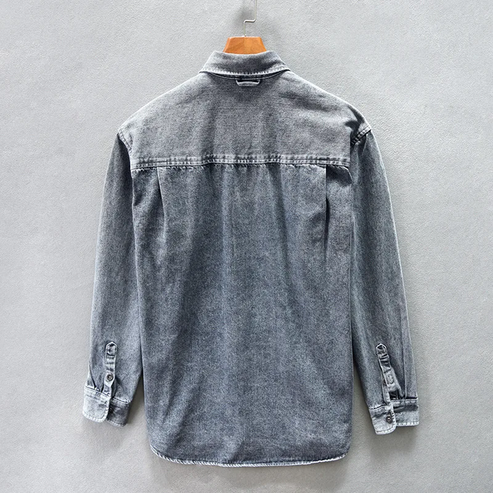 Close-up of a stylish gray casual button-up shirt, showing the fabric texture and functional buttons.