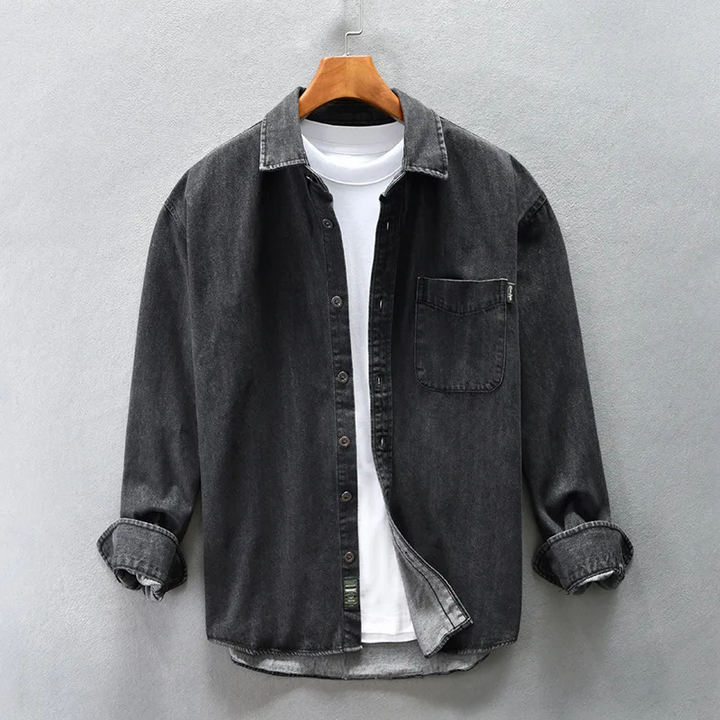 Relaxed fit black button-up shirt, ideal as a layering top or worn casually for comfortable everyday wear.